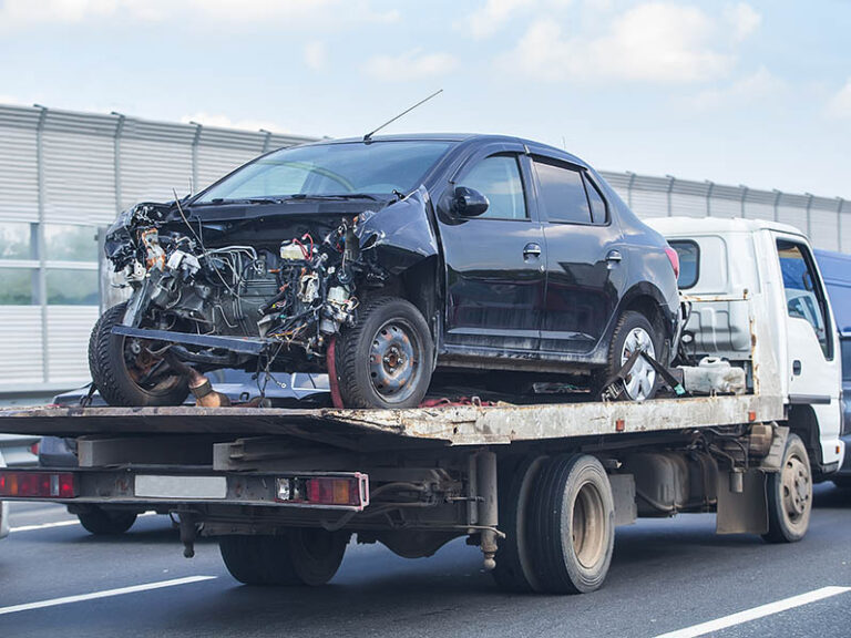 wrecker transports broken car